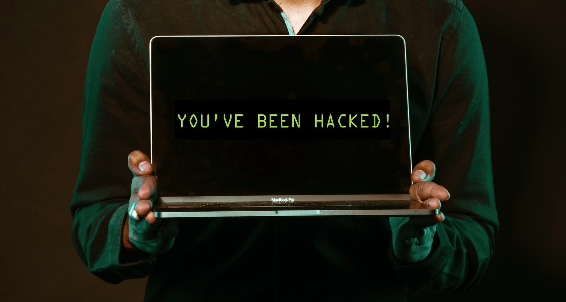 Laptop open on desk with Thunderbolt cable attached, symbolizing security vulnerabilities in Thunderbolt ports